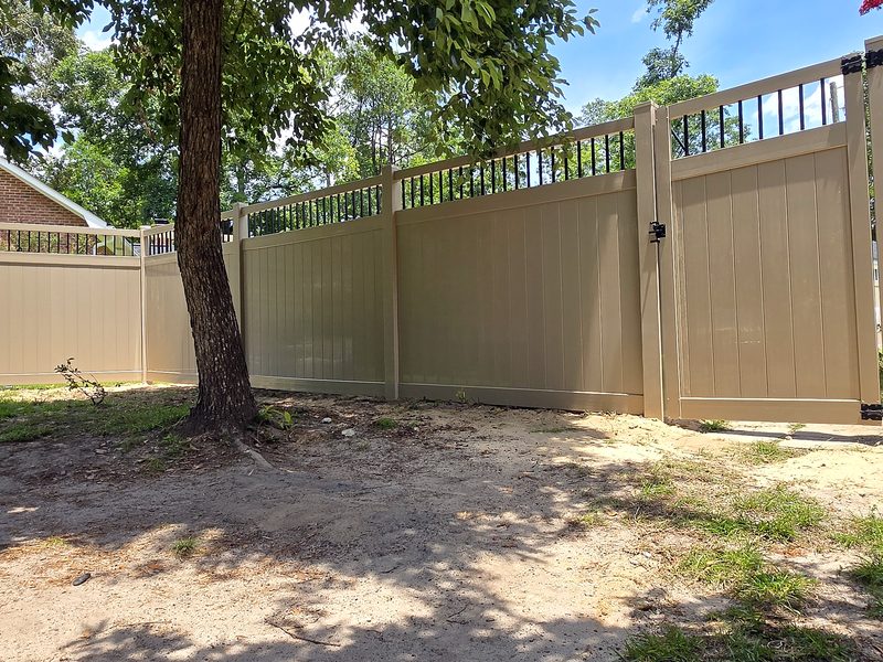 New Adobe vinyl privacy fence with a black picket top and matching gate in West Columbia, SC
