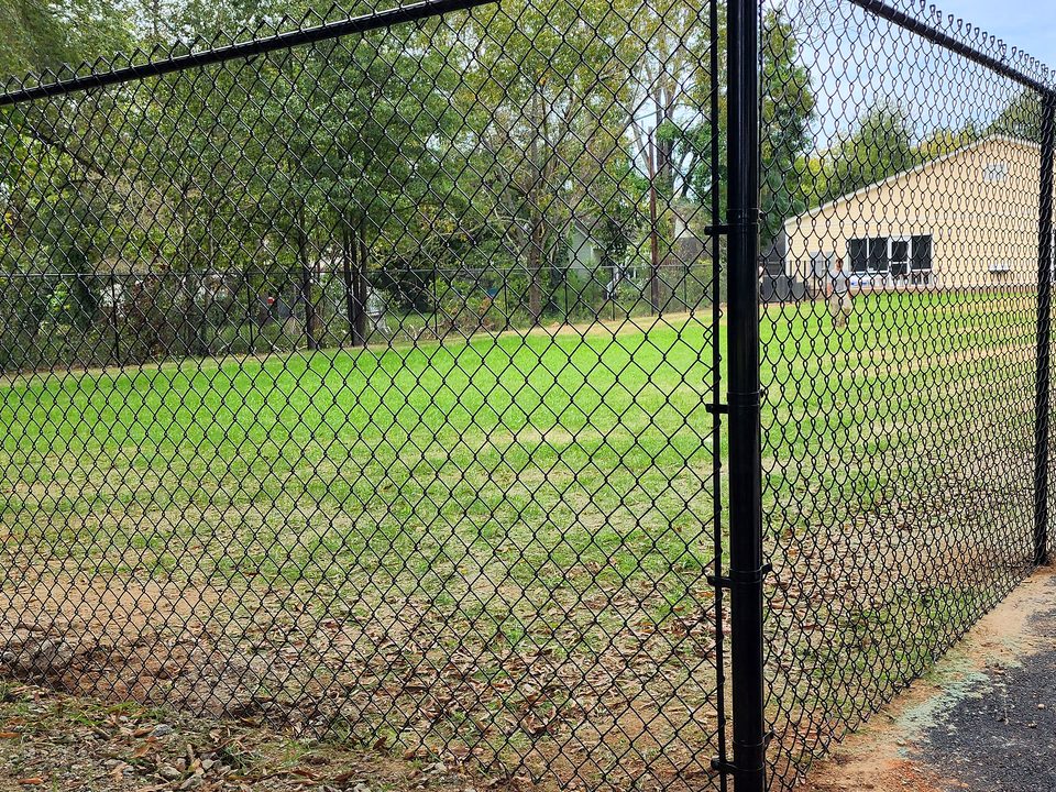 Black chain link fence along a lawn in Irmo, SC