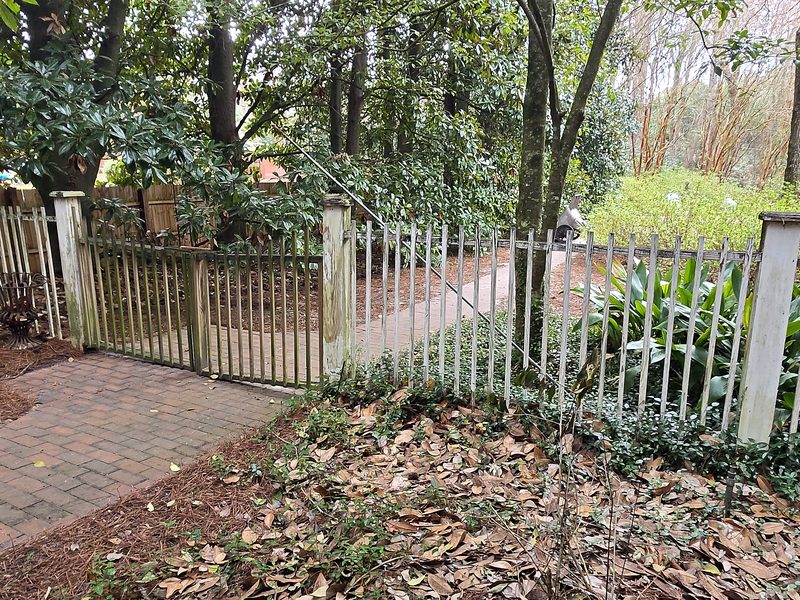 Old picket fence and gate before replacement in Columbia, SC