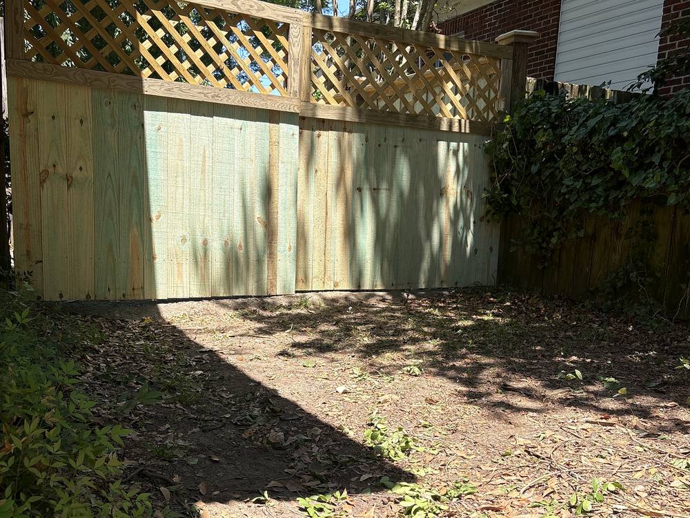 Wood privacy fence section with a lattice top beside a brick home in Irmo, SC